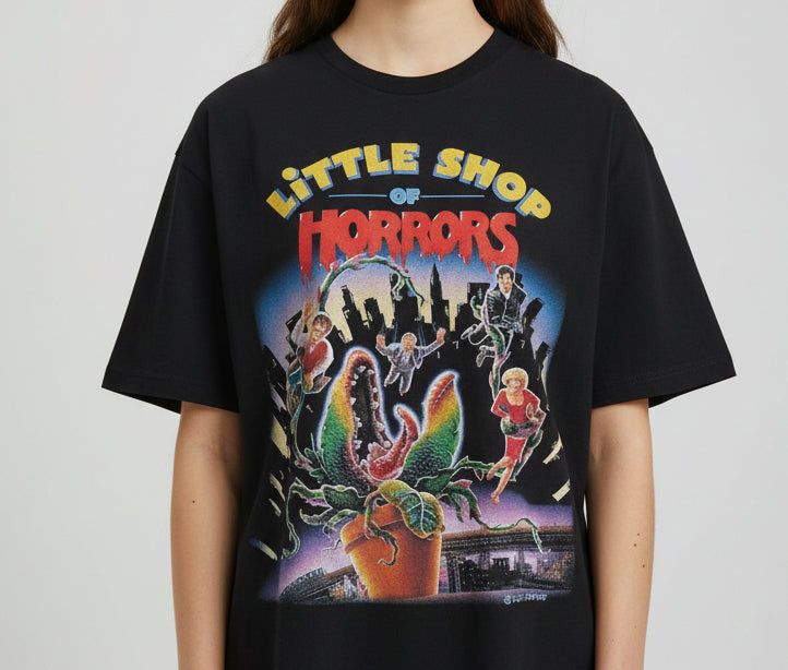 Black t-shirt with 'Little Shop of Horrors' graphic design on a white background