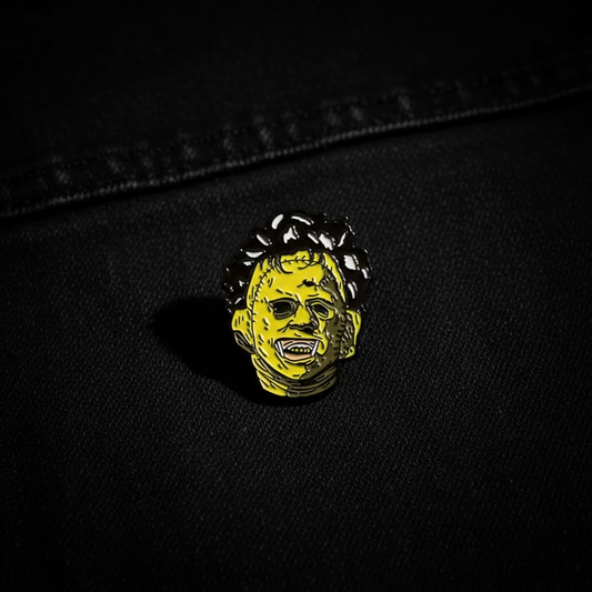 Leatherface pin on black denim background